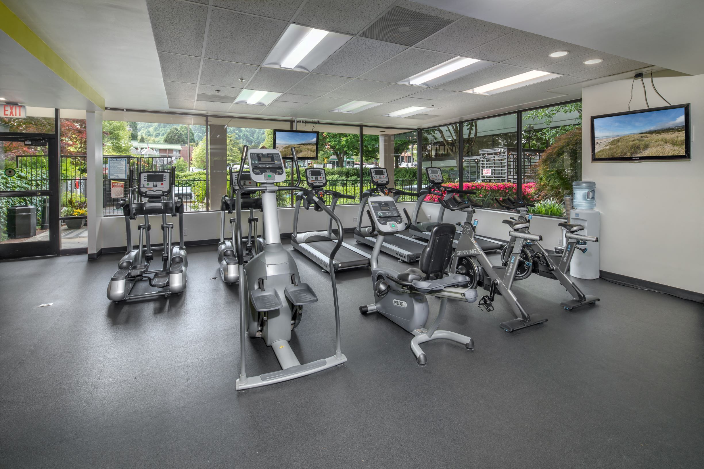 a gym with treadmills and other exercise equipment