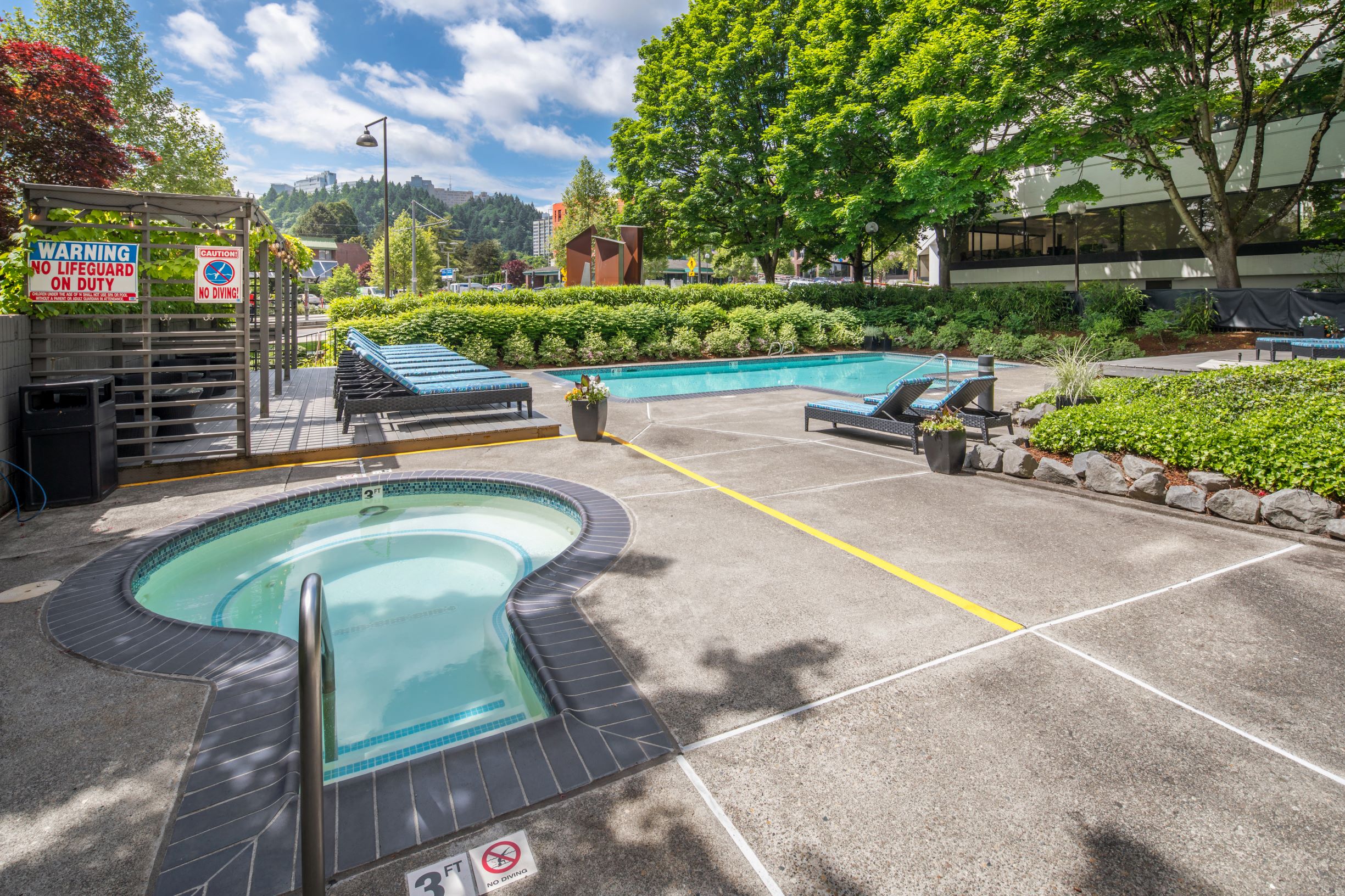 Apartments in Downtown Portland - Linc 245 Apartments Pool & Spa with Lounge Chairs and Shaded Trees