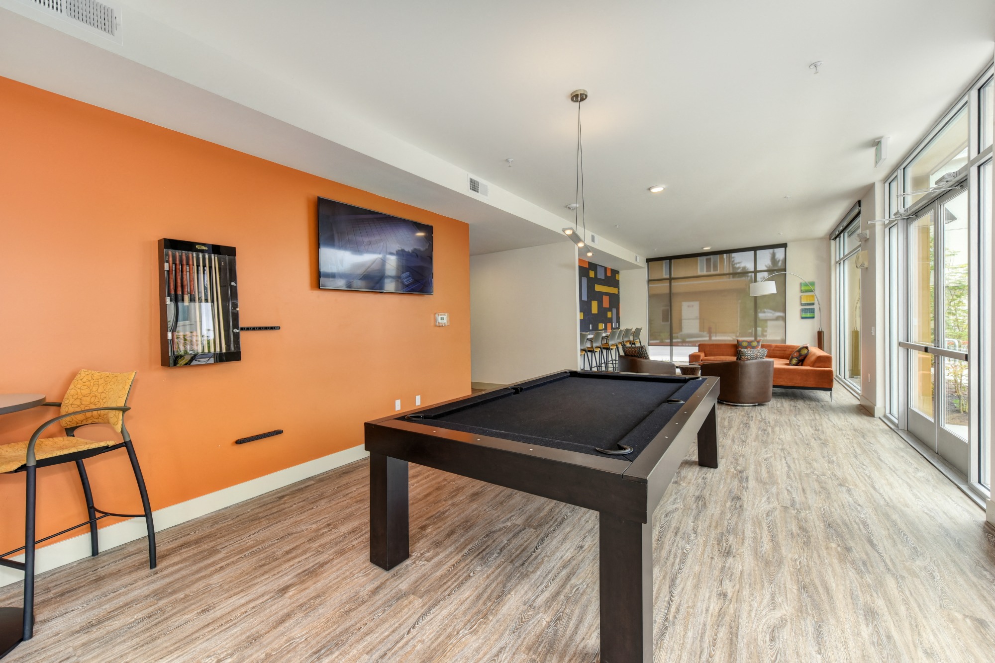 Community Clubhouse Pool Table, Hardwood Inspired Floor, Orange Walls and Window