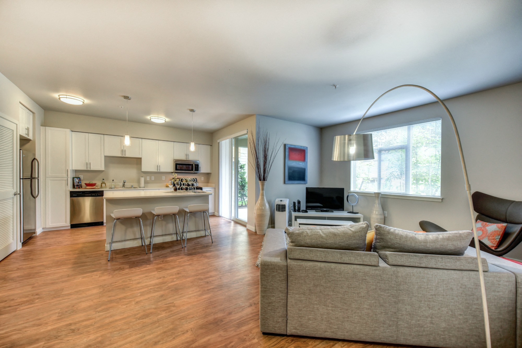 a living room with a couch and a kitchen with an island