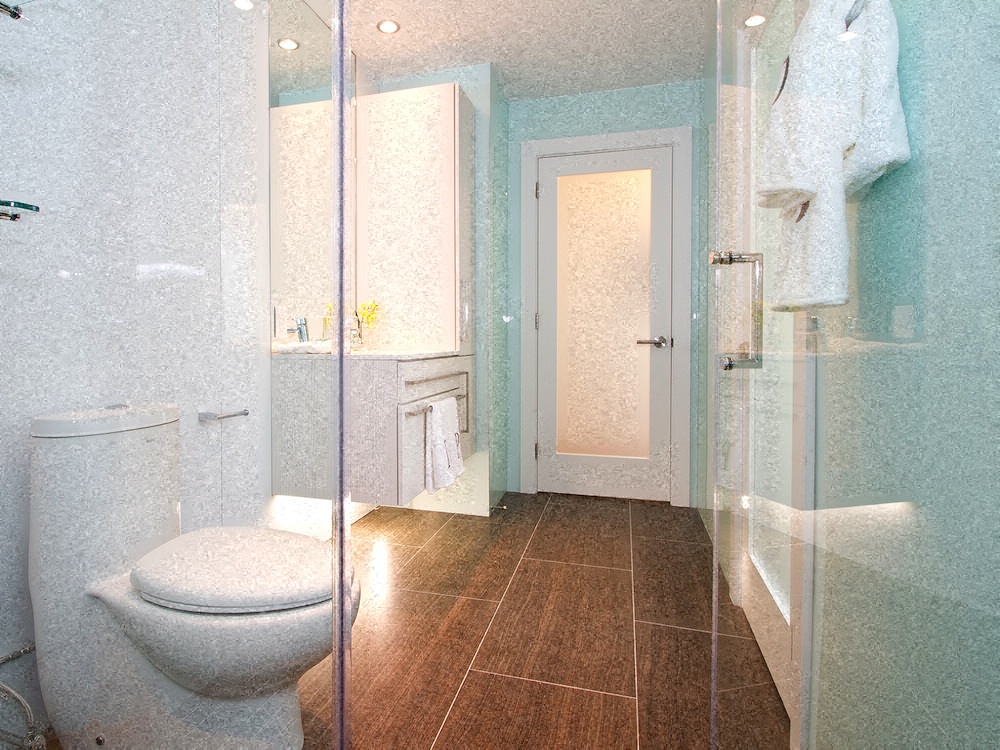 a white bathroom with a toilet and a shower