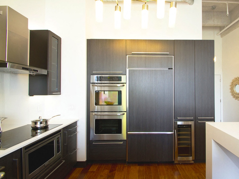 a kitchen with stainless steel appliances and black cabinets