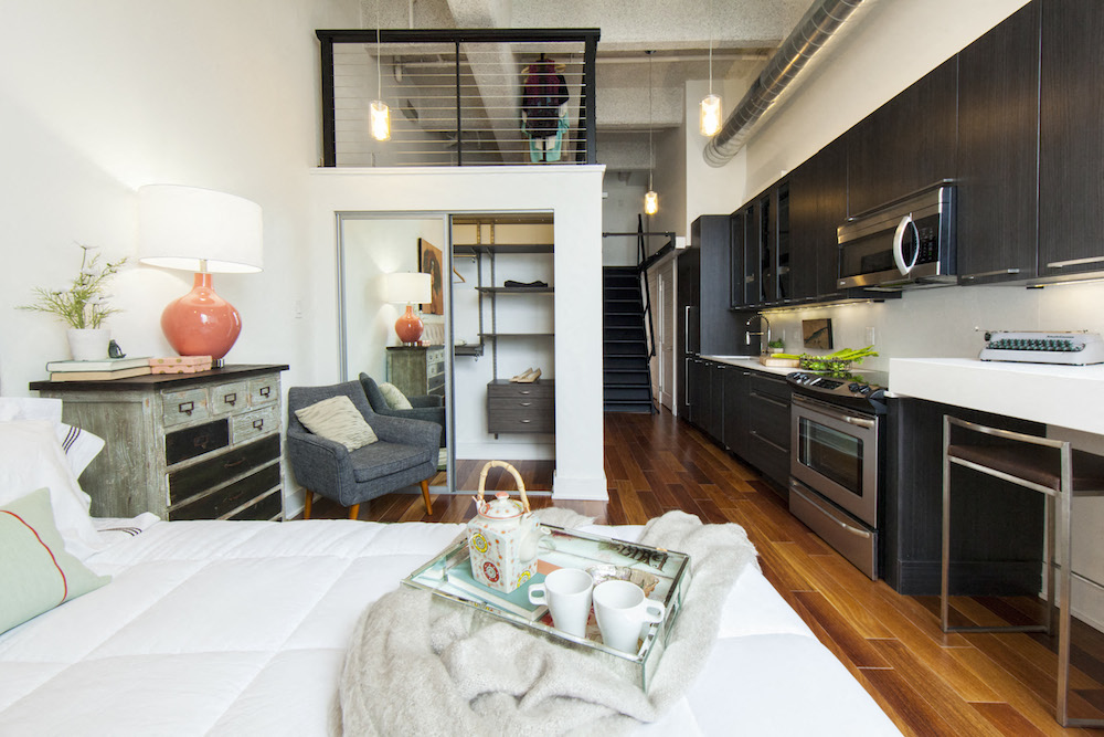 a living room with a couch and a kitchen