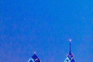 the building in which the hotel is located is lit up at night