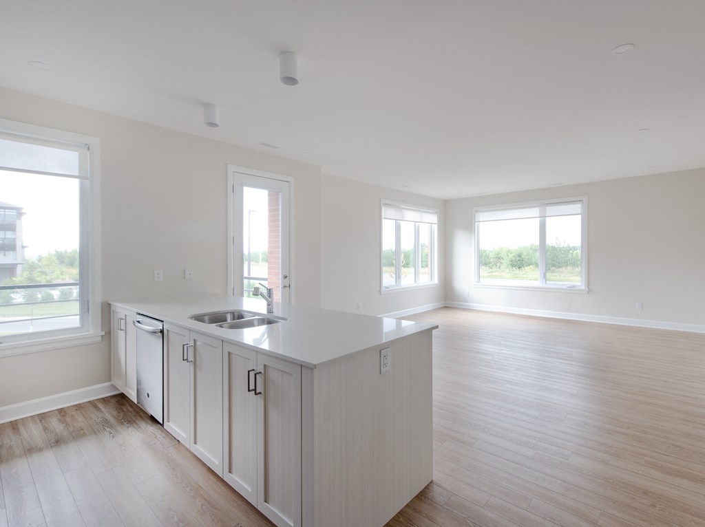 an empty kitchen with an island in the middle of it