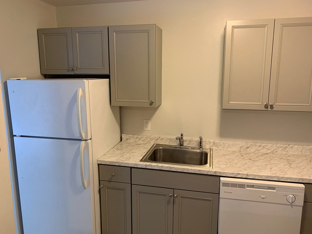 a kitchen with a sink and a refrigerator