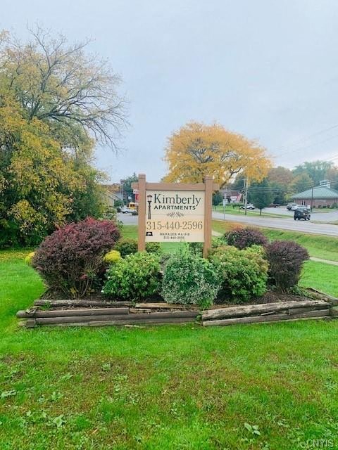 a sign for kimberly memorial park in the grass
