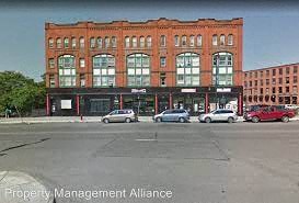 a large brick building with cars parked in front of it