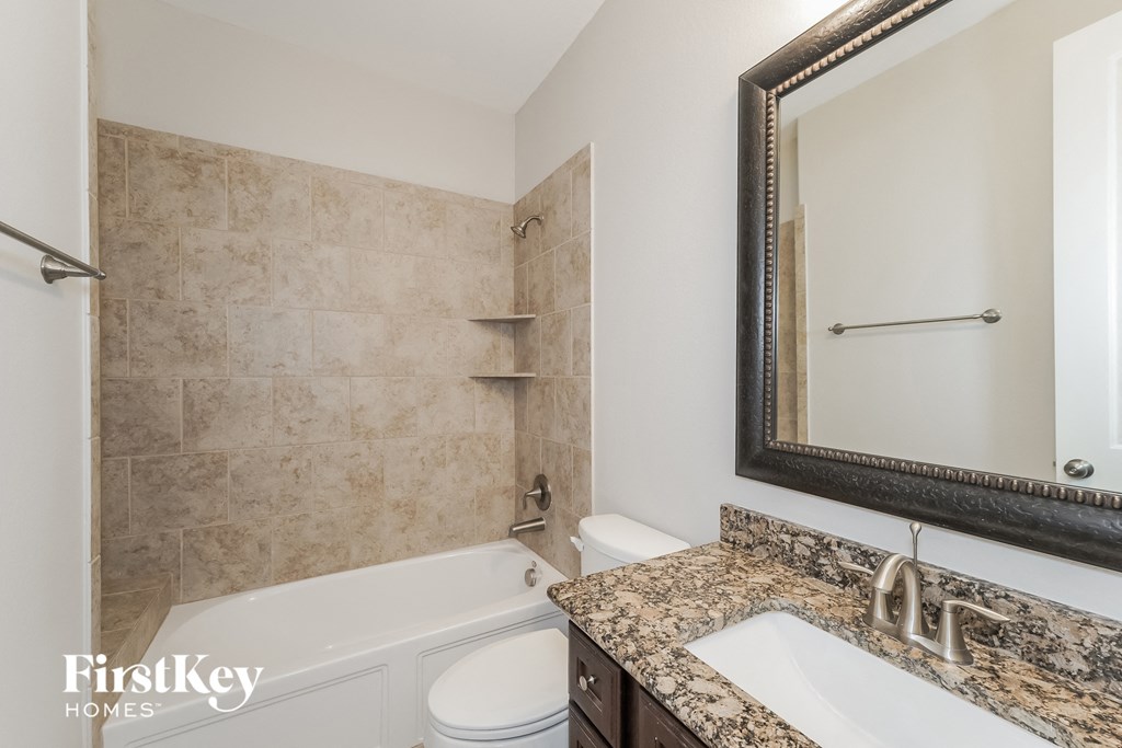 a bathroom with a tub and a sink and a mirror