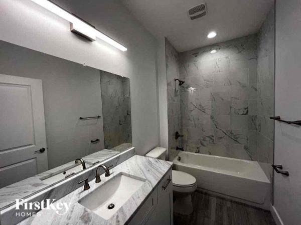 a bathroom with a sink and a toilet and a shower