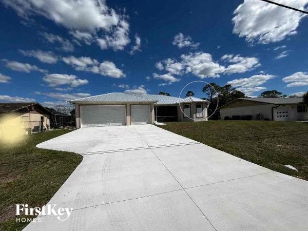 a white driveway in front of a house