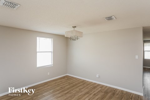 A room with wooden floors and a chandelier.