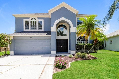 a blue house with a palm tree in front of it