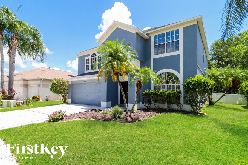 a blue house with palm trees in front of it