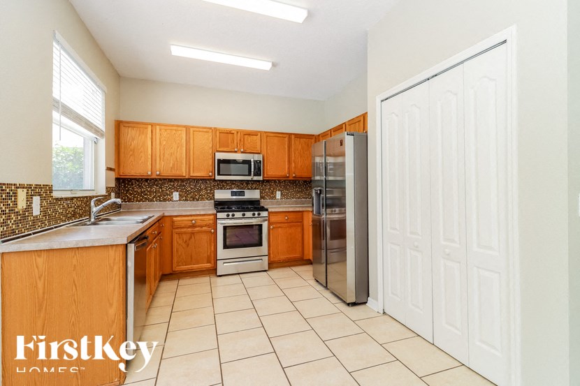 a kitchen with wooden cabinets and stainless steel appliances