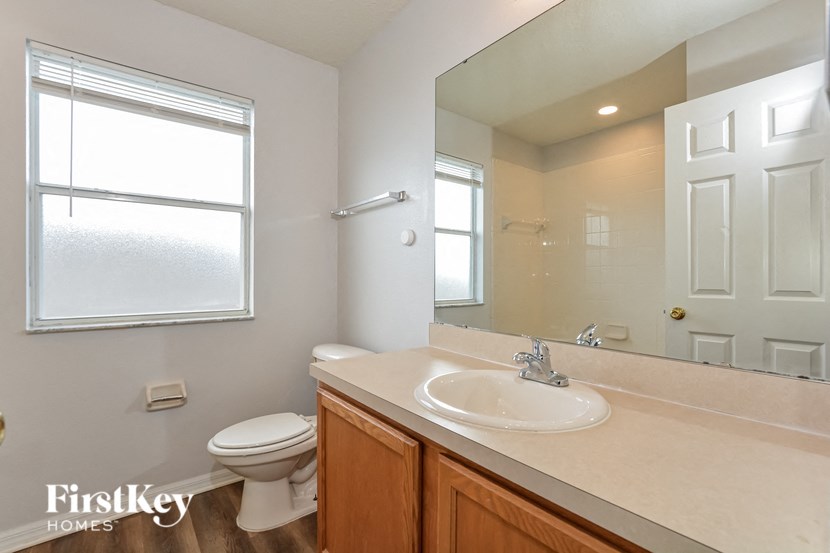 a bathroom with a toilet and a sink and a mirror