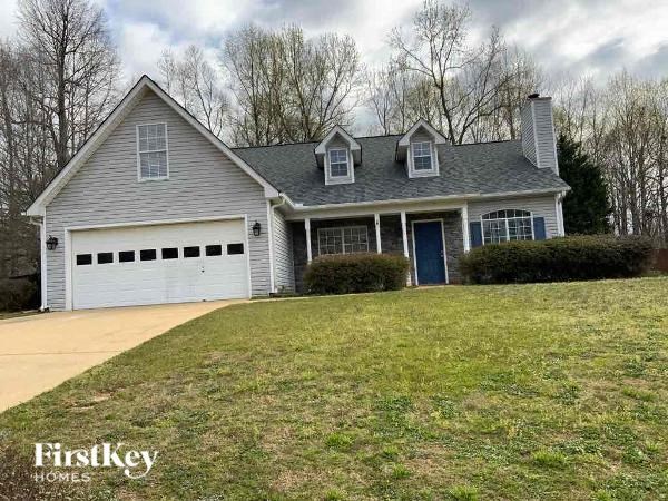 A house with a garage and a blue door is for sale.