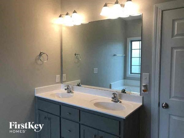 a bathroom with two sinks and a large mirror