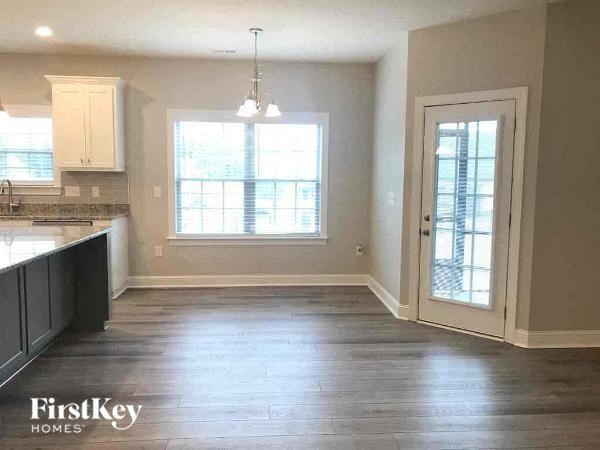 an empty kitchen with a door and a window