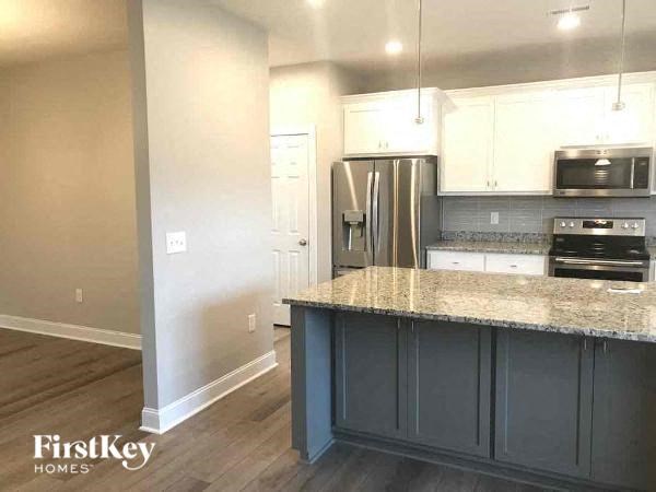 a kitchen with a counter top and a refrigerator