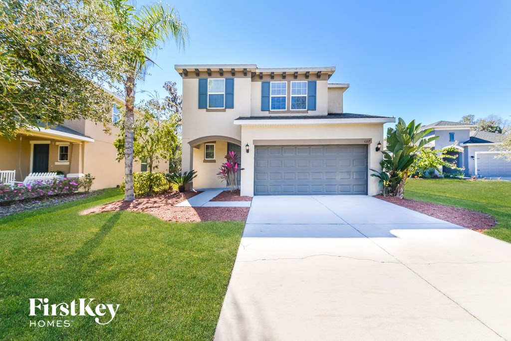 a house with a driveway and a garage door