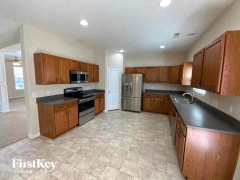a large kitchen with wooden cabinets and stainless steel appliances