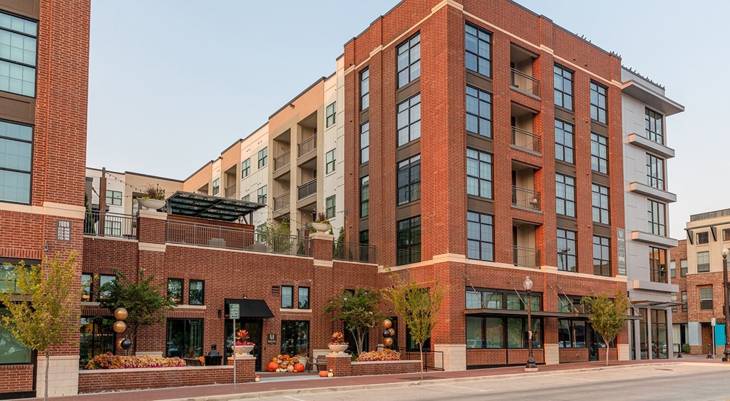 a large brick building with a street in front of it
