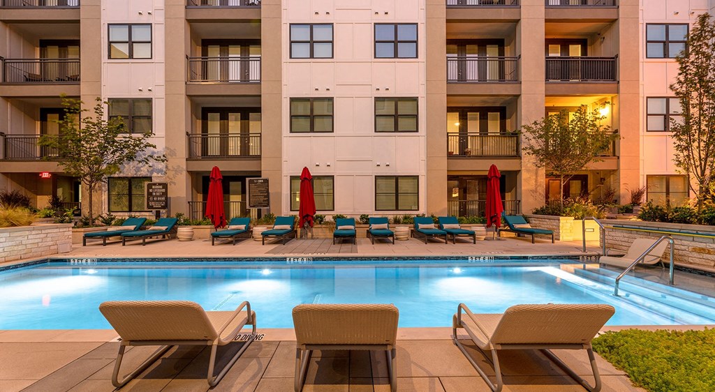 a swimming pool in front of an apartment building