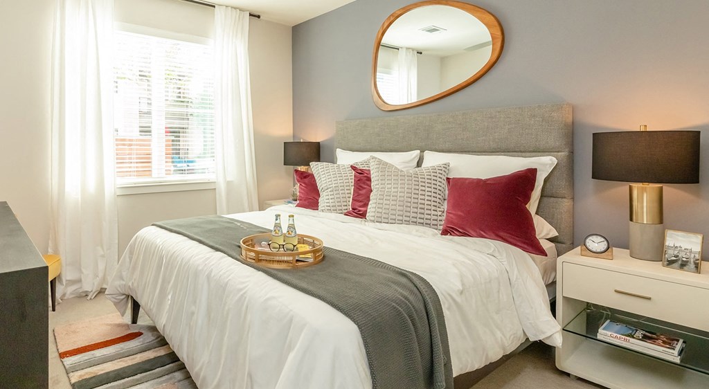 a bedroom with a bed and a mirror