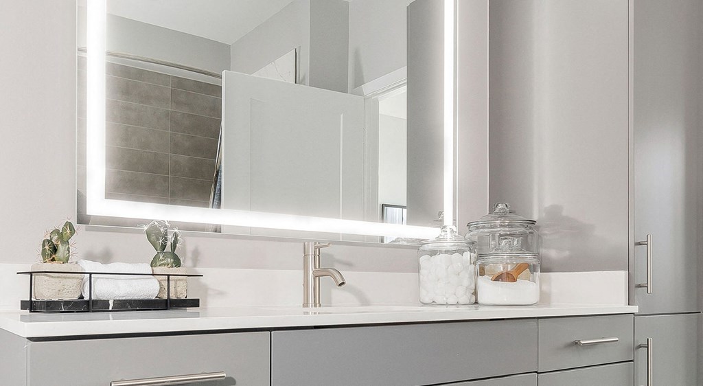 a white bathroom with a sink and a mirror