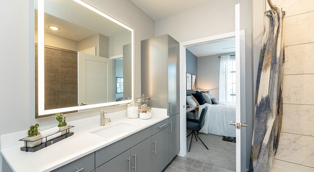 a bathroom with a large mirror and a sink