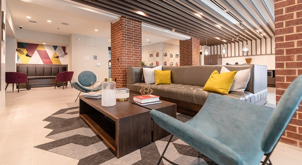 a lobby with a couch and chairs and a coffee table