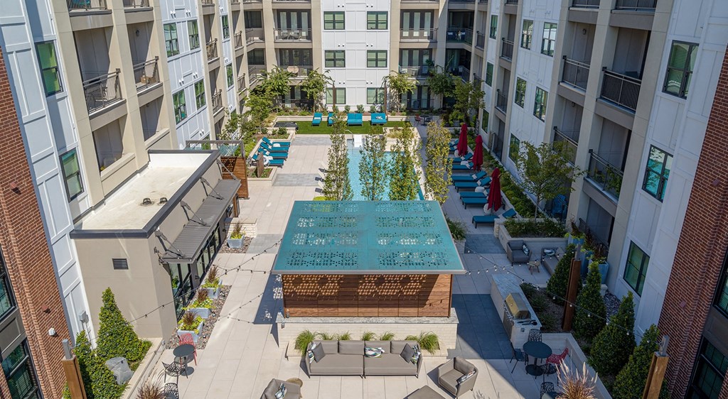 an aerial view of the courtyard of an apartment building with a pool