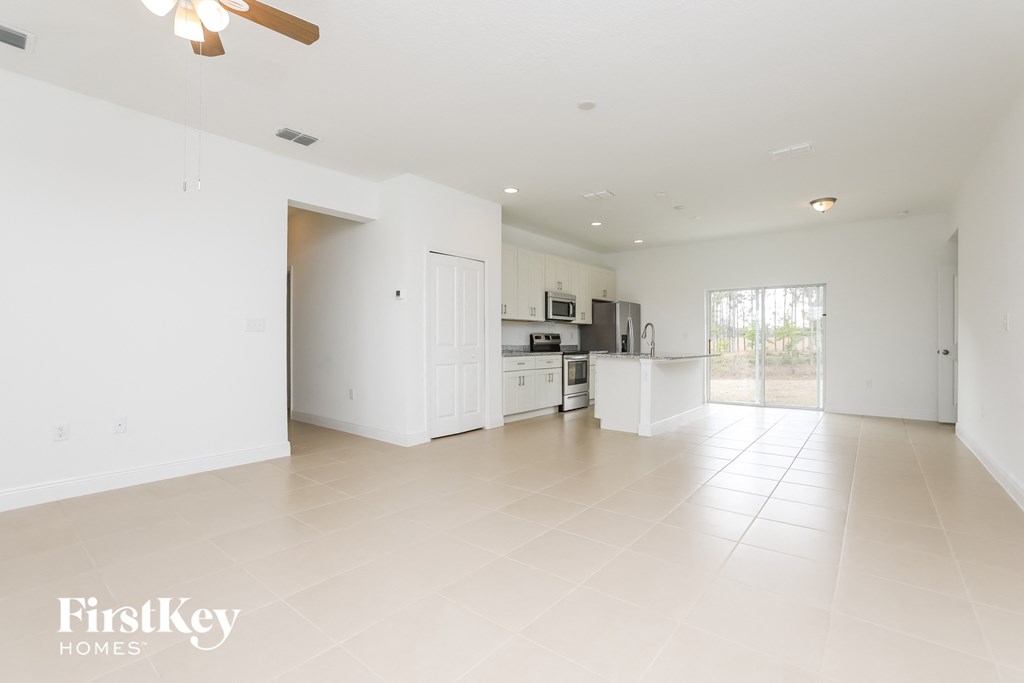 an empty living room and kitchen in a house