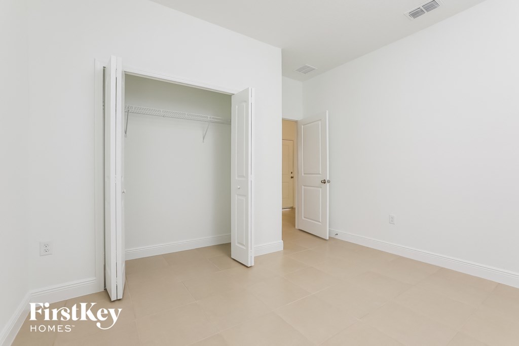 a bedroom with a closet and a hallway with an open door