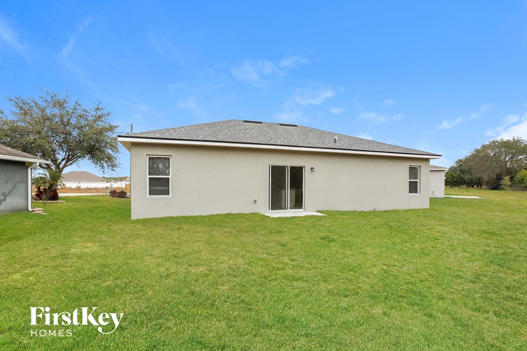 a small white house with a grassy yard