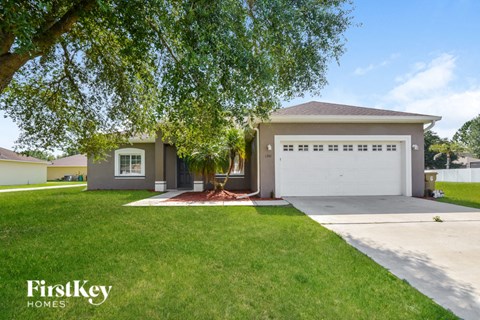 a house with a white garage door and a lawn
