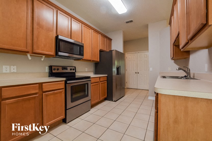 a kitchen with wooden cabinets and stainless steel appliances