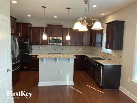 a kitchen with an island and black appliances