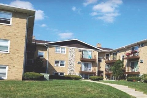 Apartment building with a clear blue sky above.