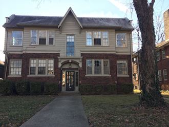 the front of a house with a sidewalk in front of it