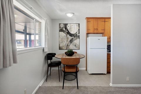 A small dining area with a table and chairs.