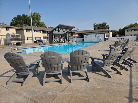 A pool with chairs around it.
