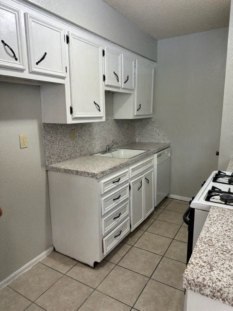 a kitchen with a sink and white cabinets