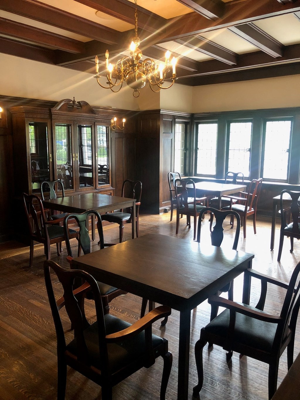 a dining room with tables and chairs and a chandelier