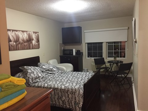 a bedroom with a bed and a table and chairs
