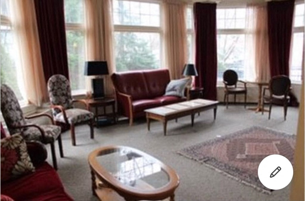 a living room with a couch and chairs and a table