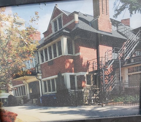 a red brick house with a fire escape