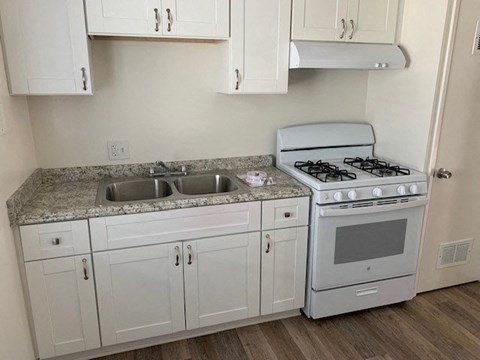 a small kitchen with a stove and a sink