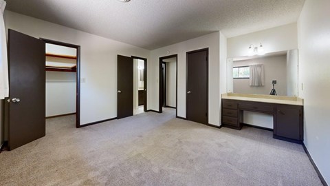 A spacious room with a sink and mirror.